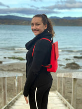 Load image into Gallery viewer, orange harakeke weave on red · red backpack