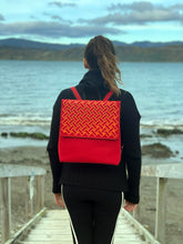 Load image into Gallery viewer, orange harakeke weave on red · red backpack